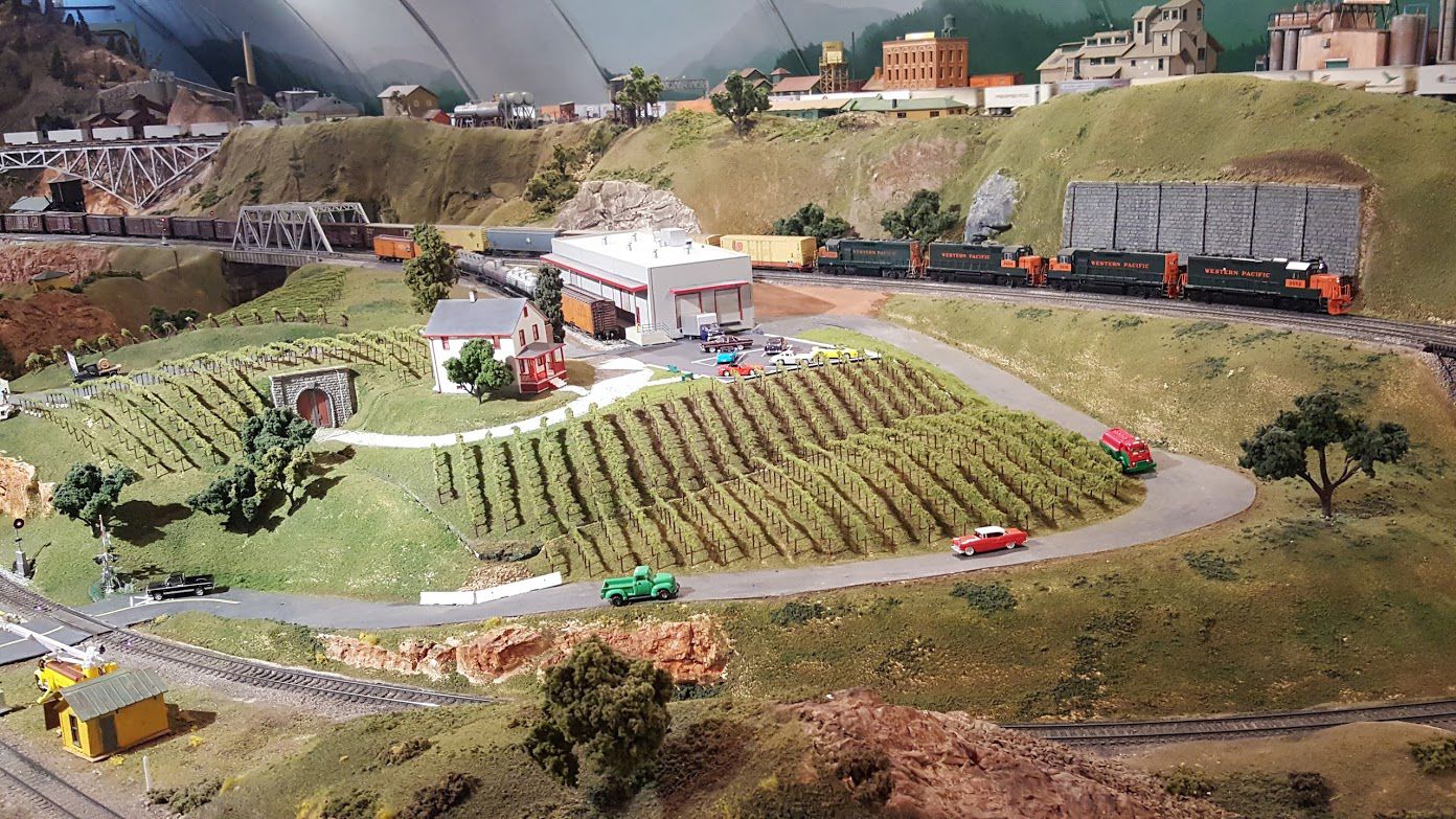 View of trains running on the layout near the winery